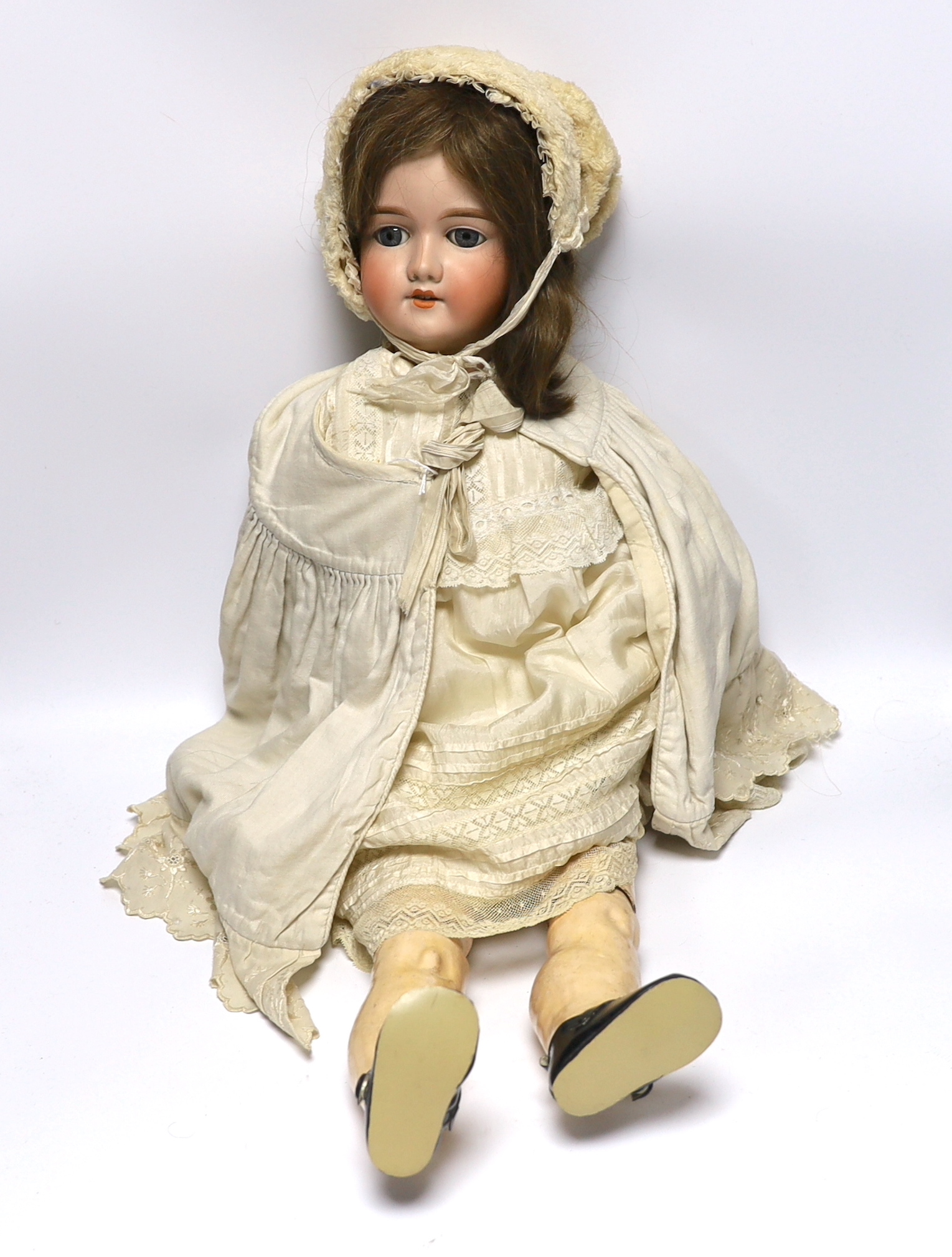 A porcelain doll, marked to the back of the neck ‘390 A12M’, 75cm